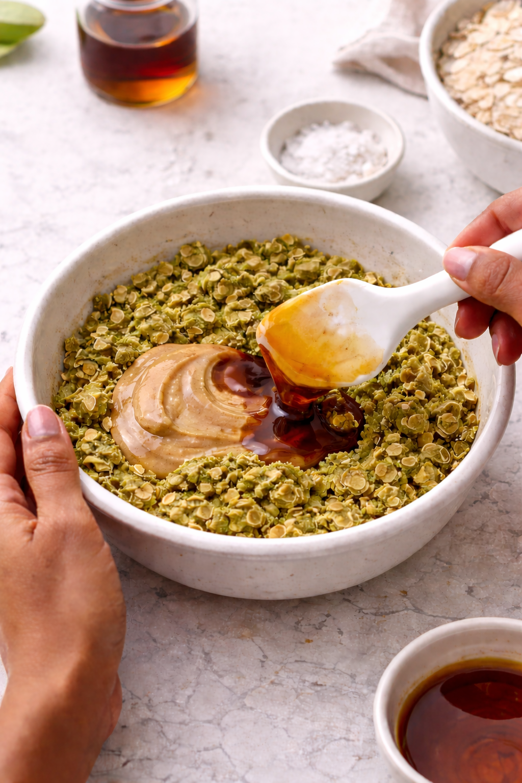 Adding nut butter and honey to matcha oat mixture