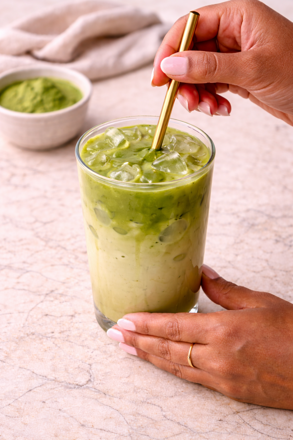 Step 5: Stirring an iced matcha oat milk latte until fully combined